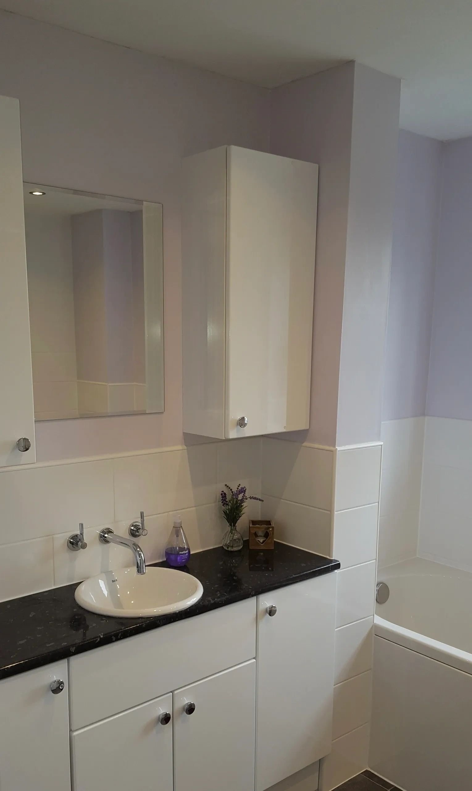 Compact bathroom vanity with dark counter