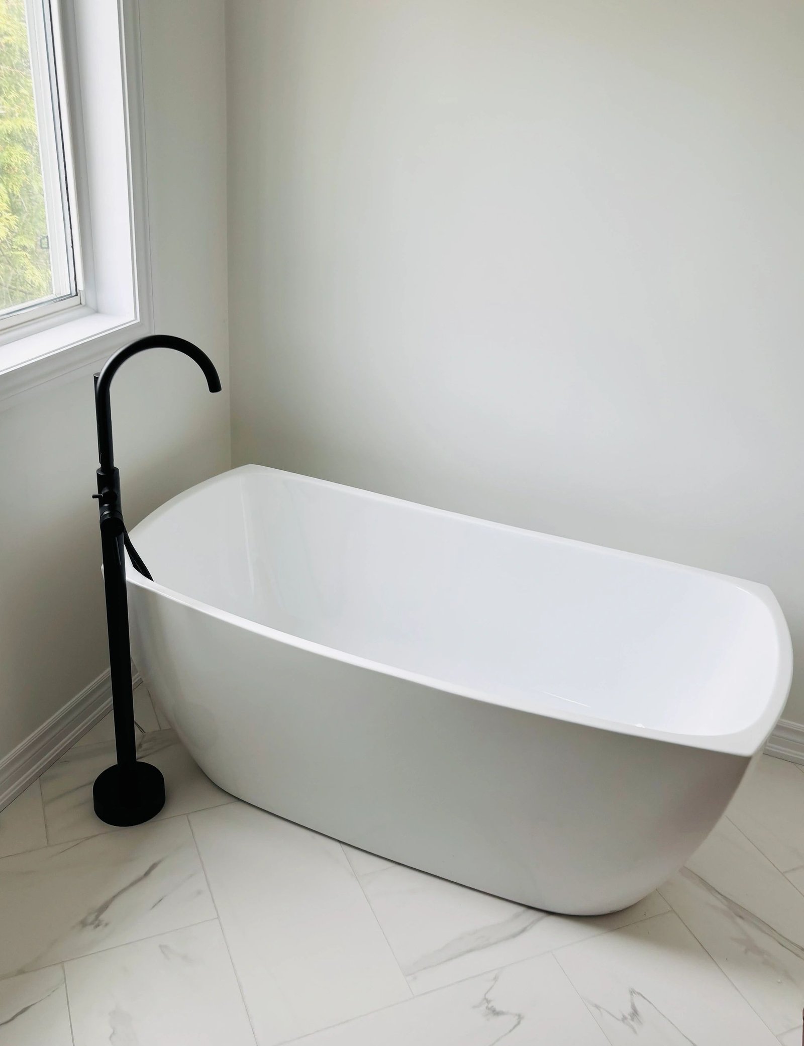 Modern freestanding bathtub with floor-mounted faucet